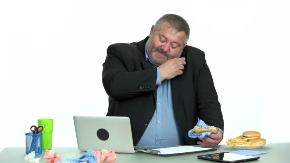 Businessman Enjoying Junk Food at Office