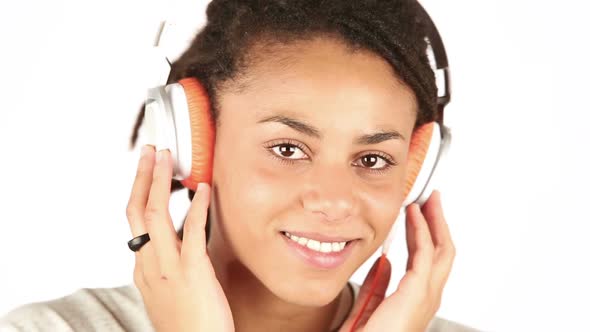 Young Woman Listening Music with Headphones and Flirting with Camera