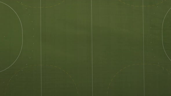 Aerial view of a sport field that moves closer to the field until you can see the artificial grass