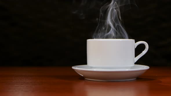 Cup of Coffee Costs on a Wooden Table and Spreads a Pleasant Smell