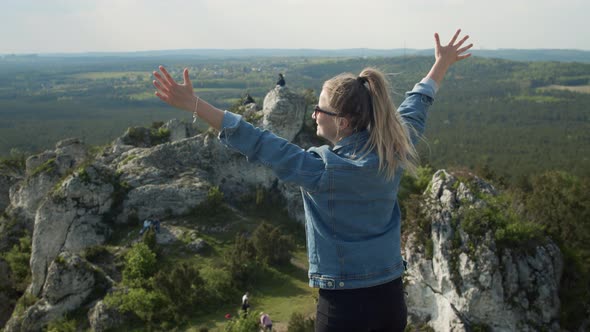 Woman Reaches Clifftop