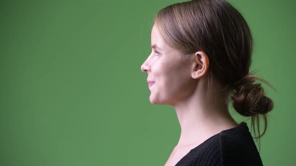 Head Shot Profile View of Young Happy Businesswoman Smiling