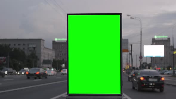 Green Screen Billboard on a Busy Highway with Traffic Neon Lights