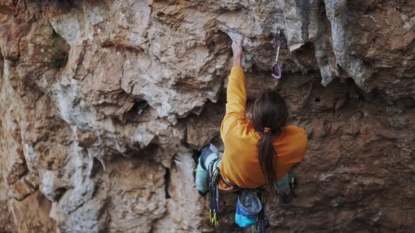 Sports Man Climber Climbing on the Rock Route Making Hard Move and Cliping Rope