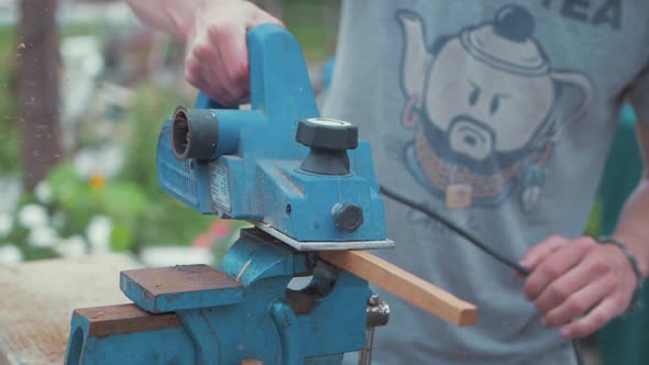 Electrical planer planing wooden teak strip slow motion