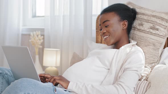 Happy African American Girl Pregnant Woman Ethnic Black Expectant Mother Uses Laptop to Communicate