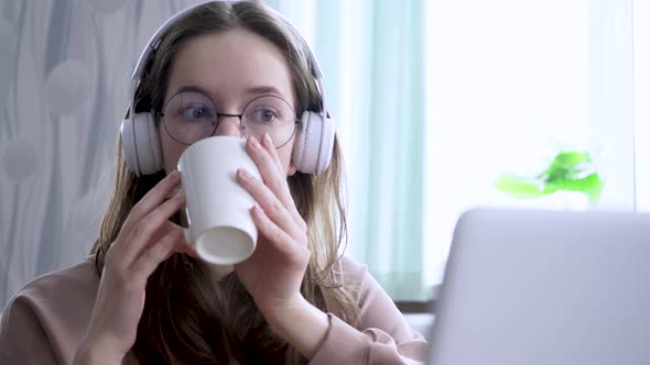 A Girl at Home Watching an Online Broadcast and Gnawing on Cookies