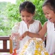 Two girls do volcano experiment at their house - VideoHive Item for Sale
