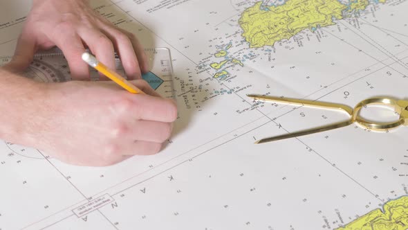 Man is Making a Course on the Nautical Map