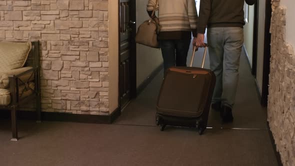 Elderly Caucasian Husband and Wife Moving into Hotel Room