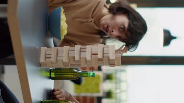 Vertical Video Men and Women Playing Board Games with Tower Cubes