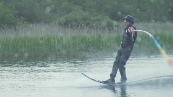 Young man performs slalom skiing cut in slow motion freeskiing