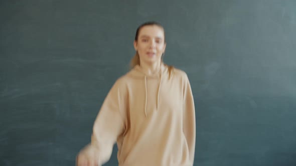 Portrait of Joyful Girl Dancing in Modern Dance Studio Alone Moving Body and Arms