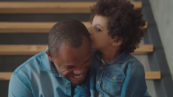 Cheerful Mixed Race Son Sharing Secret with Father