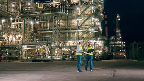 Two Inspectors are Talking About at the Oil Refinery Late at Night