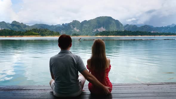 Couple on Date Sit Together on Lake Bridge Man Flirting and Getting Funny Slap