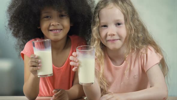 Beautiful Little Girls Sitting at the Table and Drinking Milk, Healthy Eating