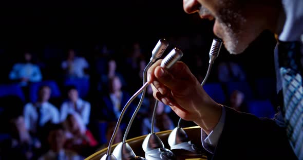 Caucasian businessman speaking in business seminar on stage in auditorium 4k