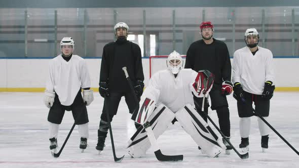 Portrait Of Hockey Players On Ice Rink