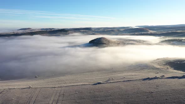 Flying Over Hills in Mystic Foggy Winter Morning