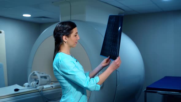 Doctor looks at an x-ray photo of a patient