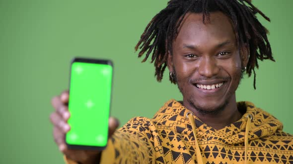 Young Happy Handsome African Man Smiling While Showing Phone