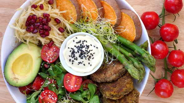 Healthy Vegan Lunch Bowl. Avocado, Chickpea Patties, Yams, Vegetable Salad. 