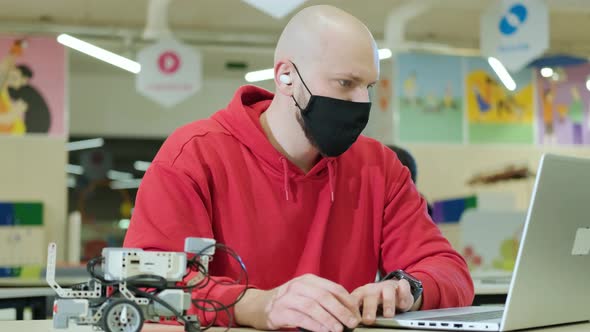 Robotics Teacher Who Teaches an Online Course for His Students Using a Computer