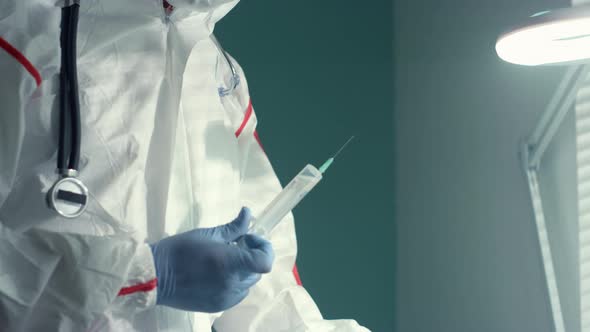 Doctor Draw Medical Syringe Using Drip Bag in Hospital Infectious Disease Unit