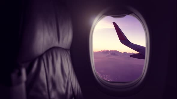 Window View From Passenger Seat On Commercial Airplane with cloud scape,