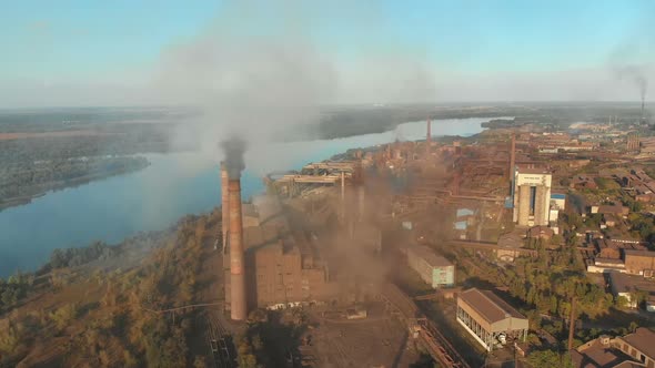 Aerial View of the Industrial Plant with Smoking Pipes Near the City. Industrial Zone