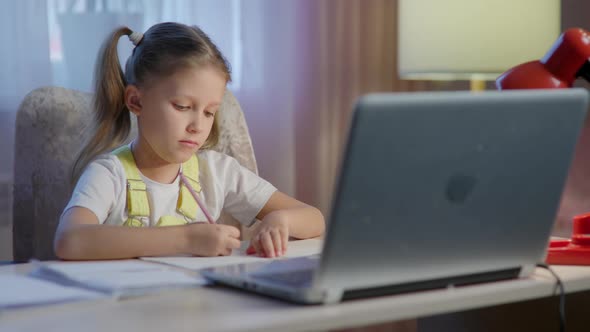 Schoolgirl Girl Studies Online On Laptop At Home