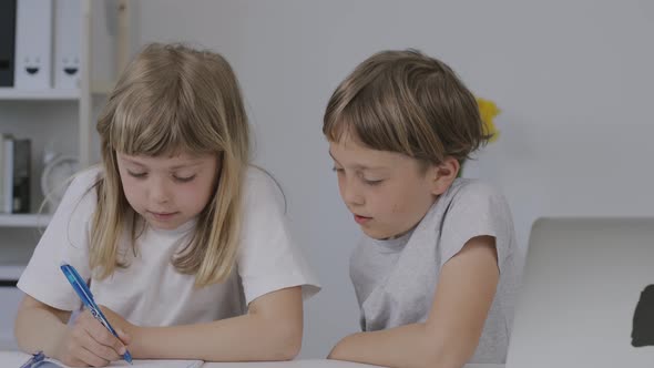 Brother Helps His Younger Sister to Make Her Homework