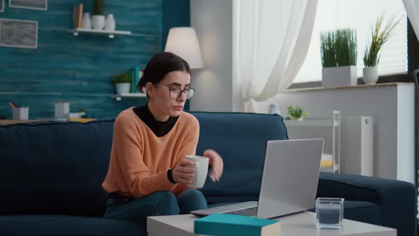 Young Woman Using Laptop to Talk on Online Video Call alt