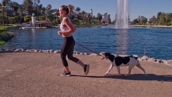 Attractive Woman Jogging With Her Dog