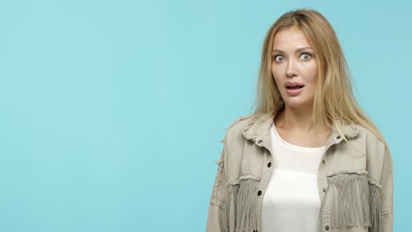 Slow Motion of Cool Attractive Woman with Long Blond Hair Turn Head and Pointing Left with Amazed