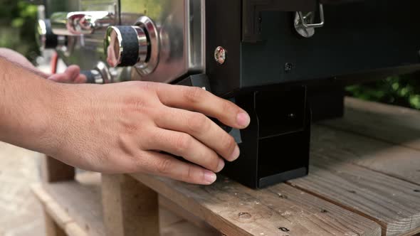 Men's Hands Prepare the Gas Grill for Work