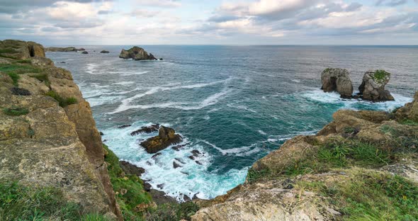  Timelapse View of Reefs and Cliffs During Sunrise at Arnia Beach. Northern Spain in Summer