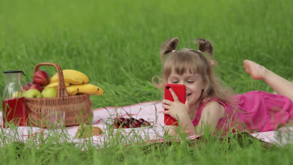 Weekend at Picnic. Girl on Grass Meadow Play Online Games on Mobile Phone. Social Network, Chatting
