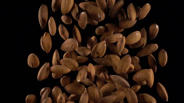 Almonds in Free Fall on a Black Background