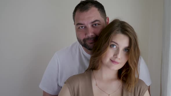 Pregnant Woman in a Brown Dress and Her Husband in a White T-shirt