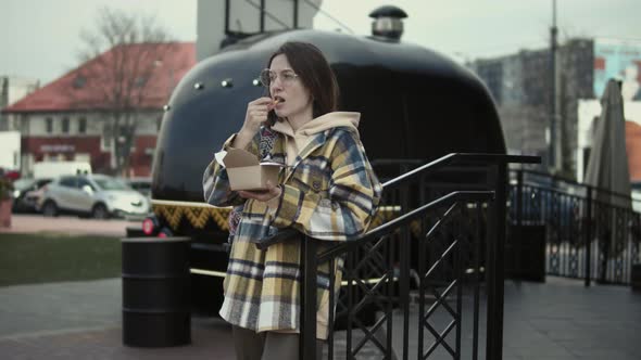 Woman eats street food from a food truck