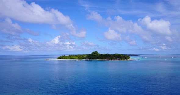 Natural fly over island view of a paradise sunny white sand beach and blue sea background in colourf