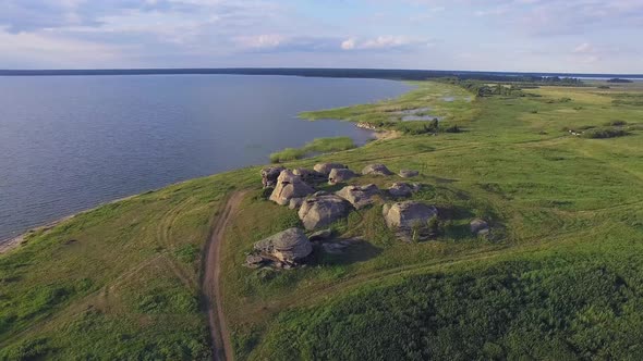 Aerial view of Huge stones (rocks) in a vast field by the lake 05