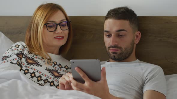 Couple searching on a tablet