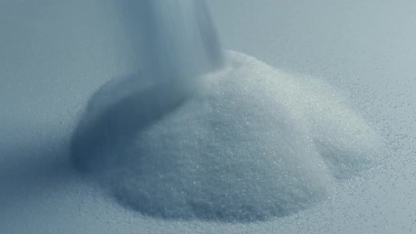 Salt Pours Onto White Surface
