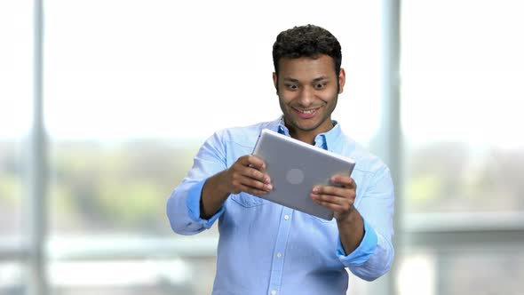 Hindu Man Playing Games on Tablet Pc with Facial Expressions