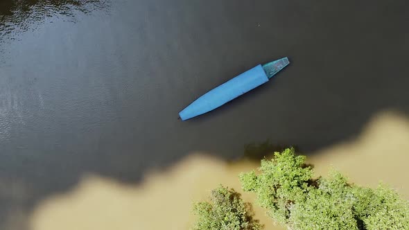 A Tourist Boat Sails Along the River Between Mountains and Green Forests in Asia Around the Jungle