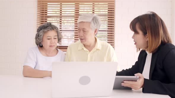 Asia smart female agent offers health insurance for elderly couples by document