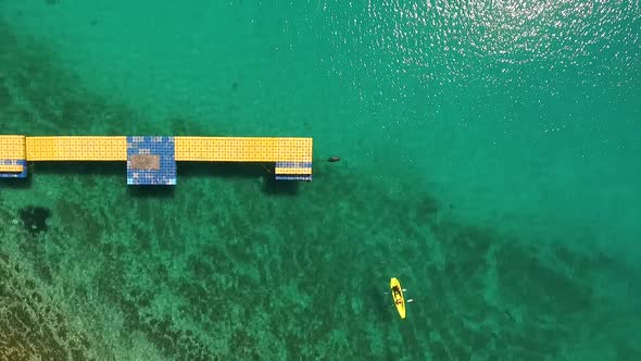 Aerial view of people kayaking near pier at the ocean, Mali Losinj, Croatia.